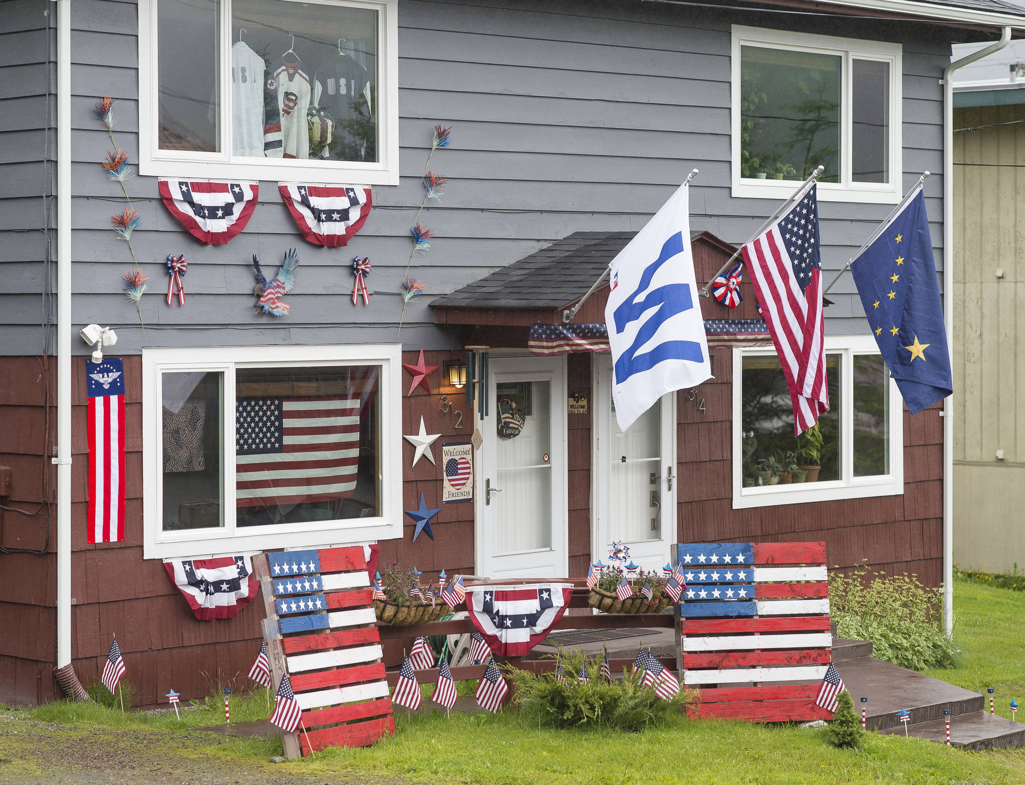 A house at 312 C Street wins first place in the Apartment/Condo/Multi category as Capital City Fire/Rescue Volunteer Firefighters Antonia Elstad and Meg Thordarson tour Douglas properties to judge on Flag Day, Thursday, June 14, 2018. (Michael Penn | Juneau Empire)