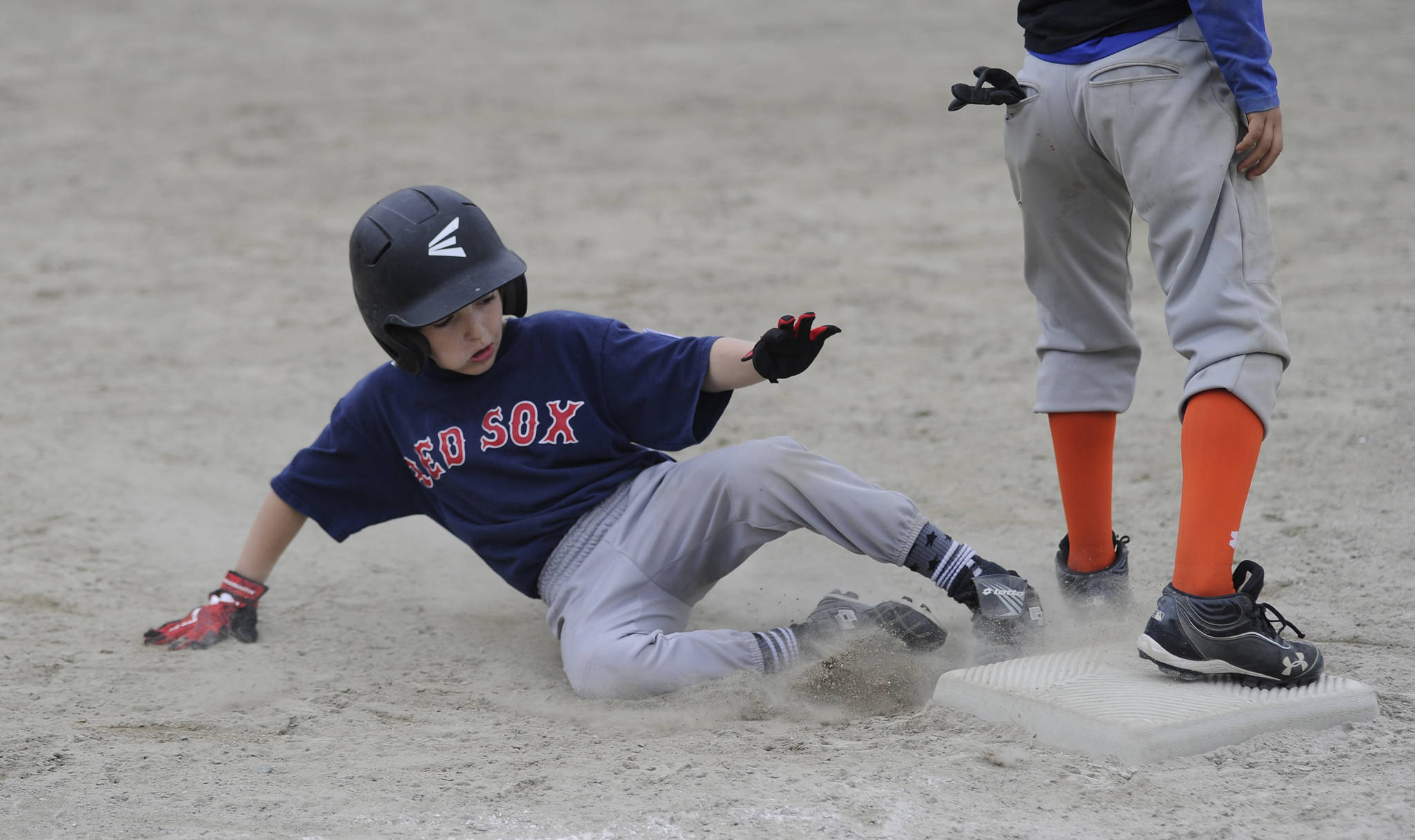 Red Sox player Eli Torres slides safely into third base in the Gastineau Channel Little League Minor Division championship game on Saturday at Miller Field. (Nolin Ainsworth | Juneau Empire)