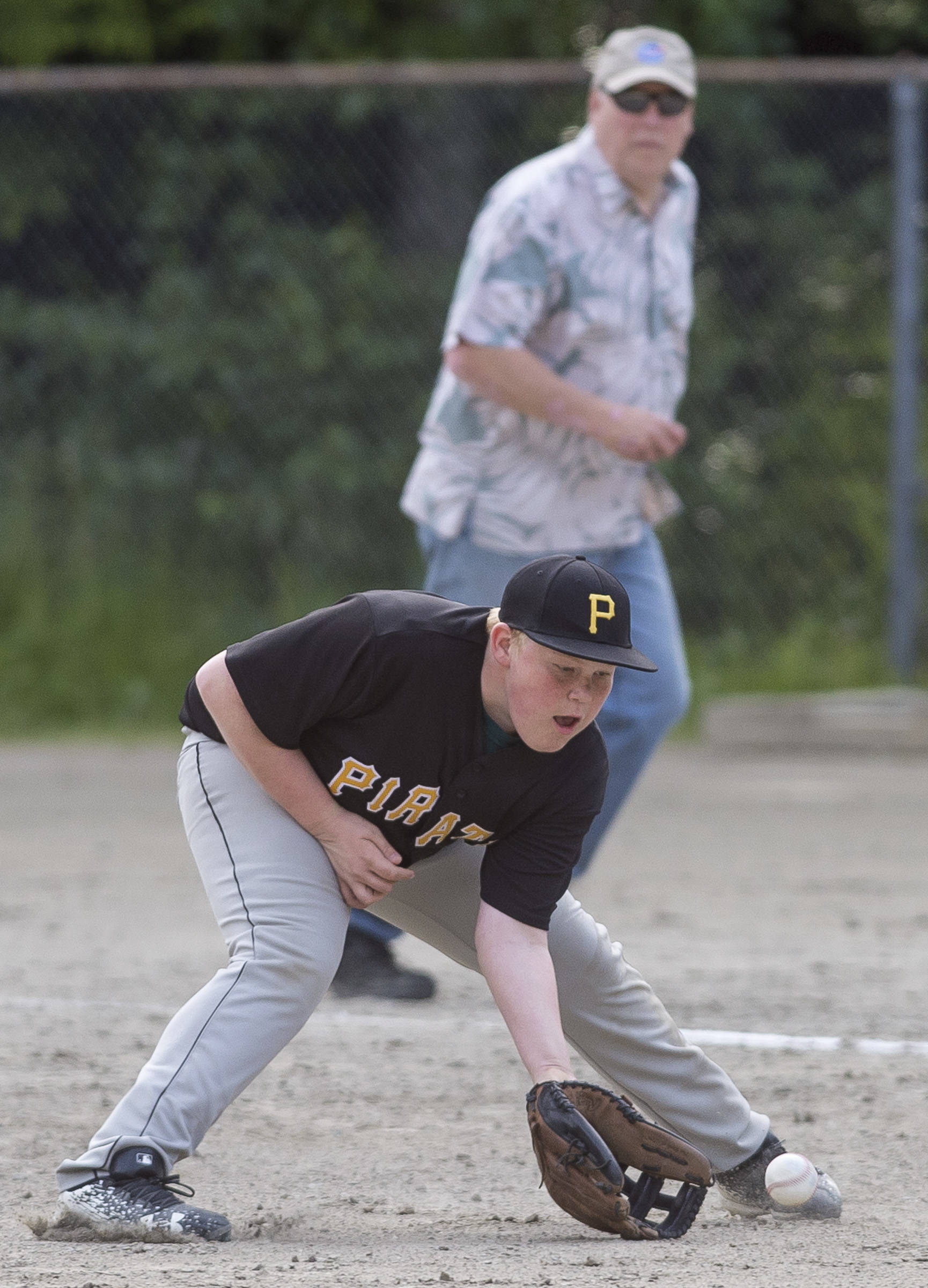 Pirates’ first baseman Mason Ackman fields a Red Sox infield hit at the Gastineau Channel Little League Junior Division Championship game at Adair-Kennedy Memorial Park on Friday. The Pirates won 8-6 on Friday and 14-3 on Saturday. (Michael Penn | Juneau Empire)