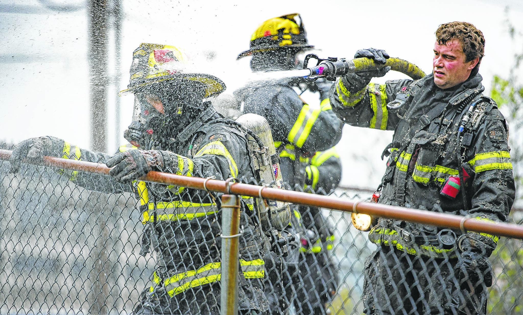 Capital City Fire/Rescue cleans up after fighting a fire at 526 Seward Street, next to the Terry Miller Legislative Building, on Sunday, Sept. 17, 2017. (Michael Penn | Juneau Empire File)
