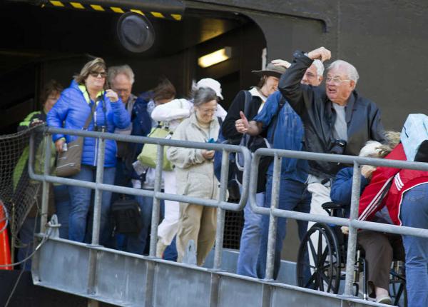 A visitor off the Holland America Line MS Westerdam loses his hat to the high winds in 2016.