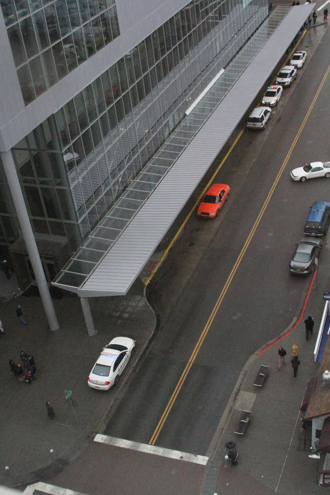 Emergency vehicles line up outside the Deni'ina Convention Center in downtown Anchorage on Oct. 17, 2015. Police responded after a person died after falling or jumping from the top-level concourse at the three-story convention center while the annual Alaska Federation of Natives conference was being held.