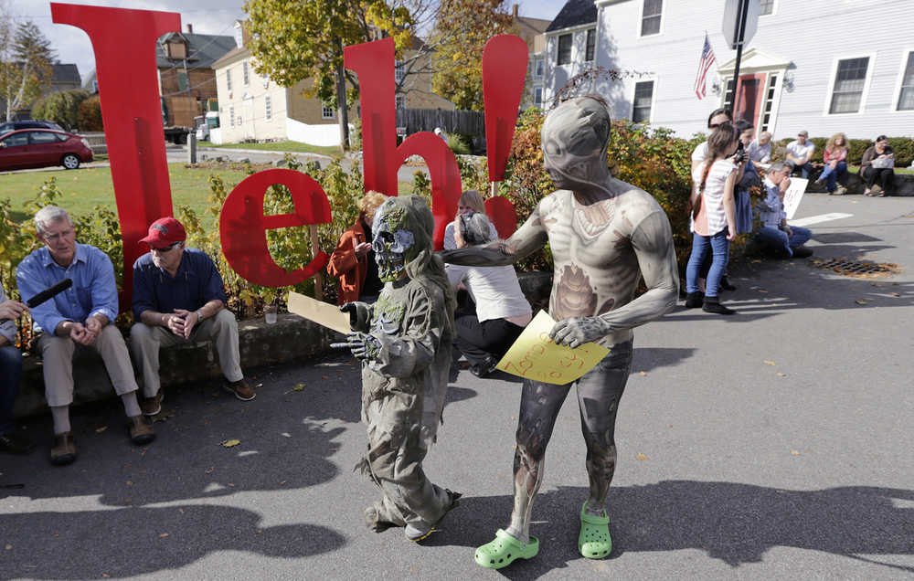 Two children dressed as zombies wait for the arrival of Republican presidential candidate, former Florida Gov. Jeb Bush during a campaign stop at Geno's Chowder and Sandwich Shop in Portsmouth, N.H., Thursday, Oct. 29, 2015. (AP Photo/Charles Krupa)