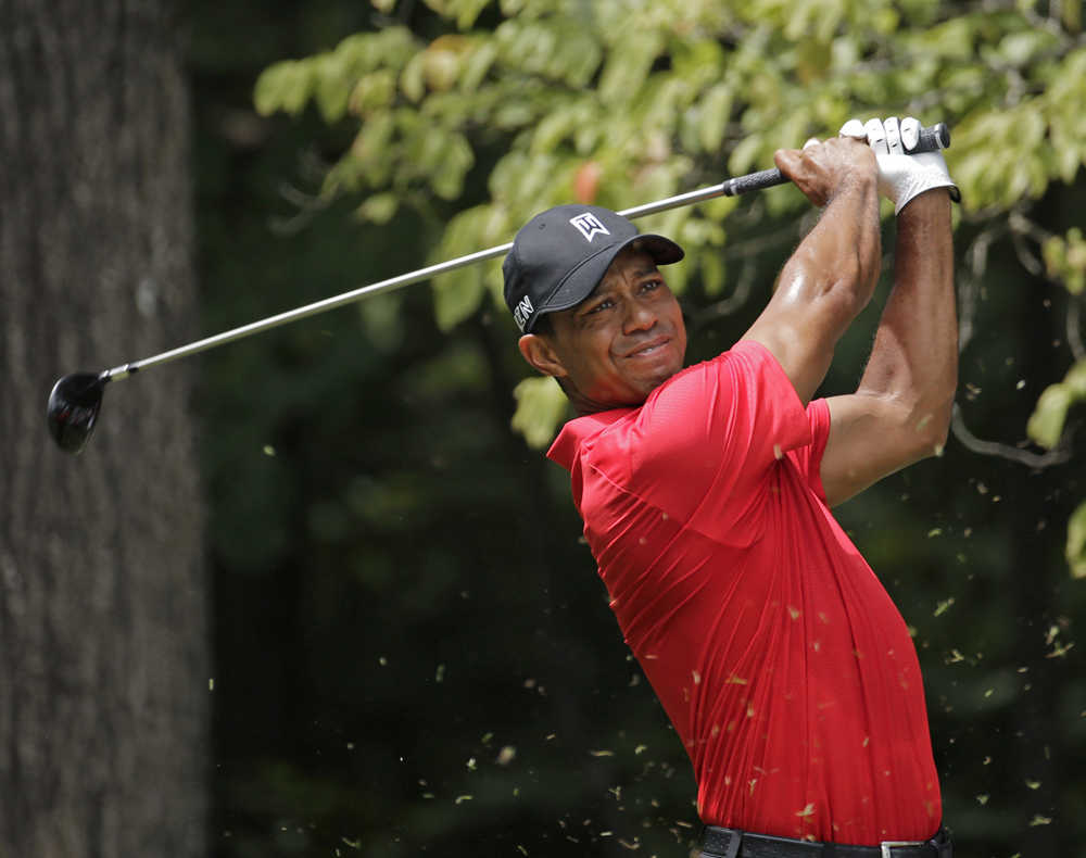 In this Aug. 23, 2015 photo, Tiger Woods watches his tee shot on the second hole during the final round of the Wyndham Championship golf tournament in Greensboro, North Carolina.