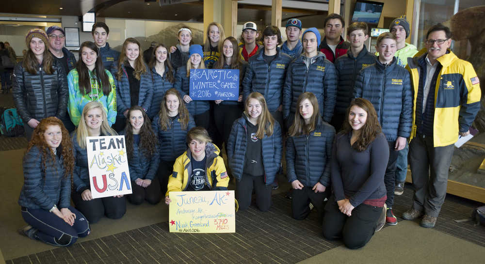 Twenty-five Southeast Alaska members of the Alaska Arctic Winter Games plus coach Gary Lehnhart, back left, and Team Alaska boardmember Jim Powell, right, pose for a picture at the Juneau International Airport on Friday before flying to Nuuk, Greenland, for a week competing against other Arctic nations. The high school students will represent Alaska in 19 different sporting events.