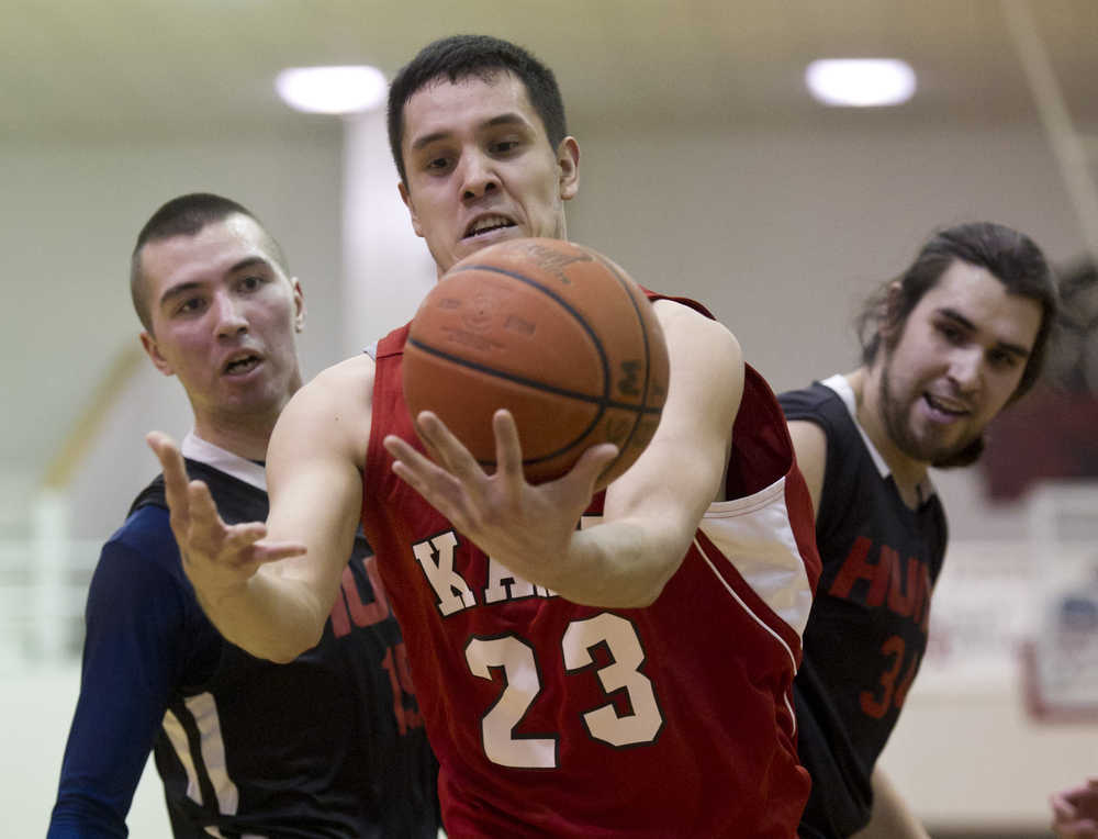 Kake's Dean Cavanaugh grabs a loose ball in front of Hoonah's Brian Koenig, left, and Brian Mills during their B bracket game in the 2016 Juneau Lions Club 70th Gold Medal Basketball Tournament at Juneau-Douglas High School on Tuesday.