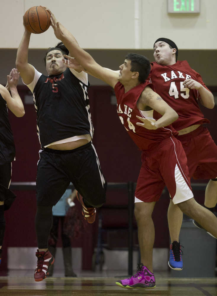 Hoonah's David Lindoff, left, rebounds against Kake's Dylan Lee, center, and Dion Jackson during their B bracket game in the 2016 Juneau Lions Club 70th Gold Medal Basketball Tournament at Juneau-Douglas High School on Tuesday.