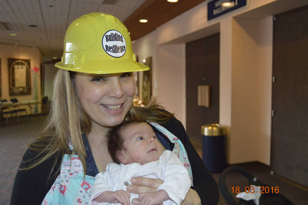 Conference volunteer for the Childhood Education Symposium Genevieve McLaughlin and her baby Scarlet.