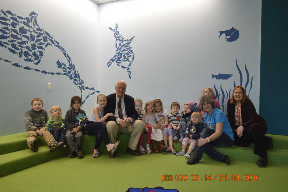 Mayor Ken Koelsch and his reading audience along with librarian MJ Grandee of the Juneau Public Libraries and Joy Lyon, executive director of AEYC-SEA.