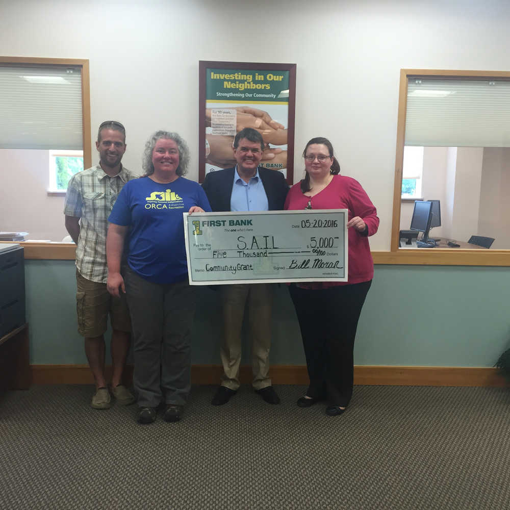 First Bank vice president Robert Anderson (second from right), presents a $5,000 check to SAIL for all donations made in their Juneau branches during this past winter's holiday donor matching campaign. From SAIL (left to right): assistant director Tristan Knutson-Lombardo, SAIL Board vice president Elizabeth Spence and SAIL Board president Kate Burkhart.