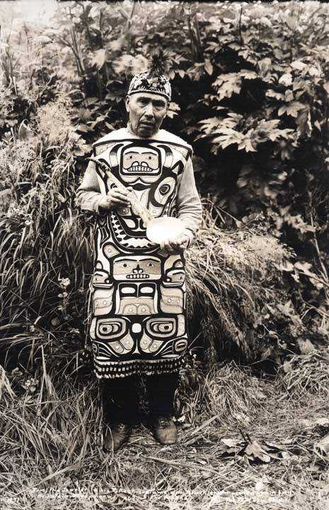 Jim Jacobs, a jeweler, in his potlatch costume with potlatch spoon carved from mountain sheep horn in Sitka in 1931.