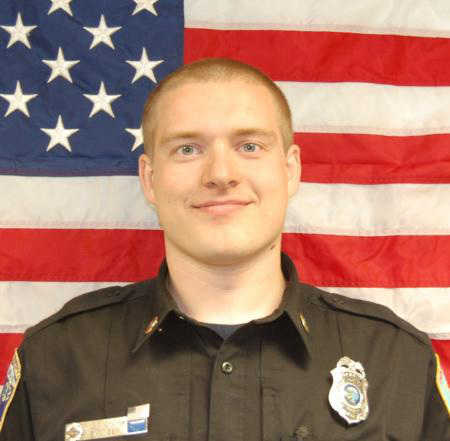 Kyle Fagerstrom poses in front of the American flag.