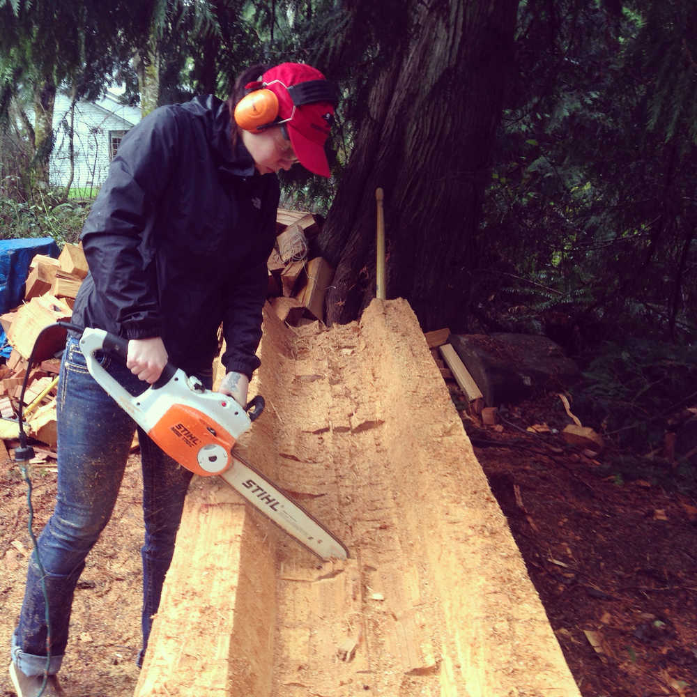 Alison Bremner works on her first totem pole, carved in honor of grandfather and made possible by the James W. Ray Venture Project Award.