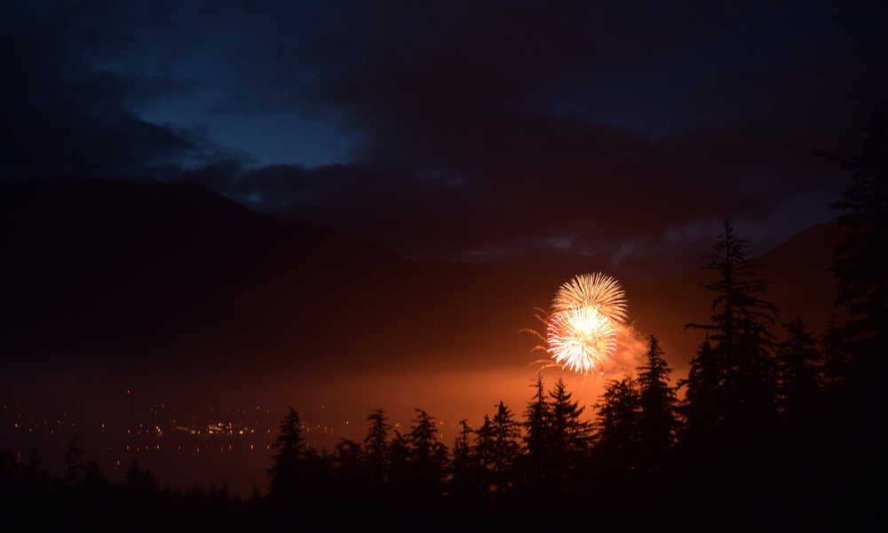 Fourth of July fireworks burst above the lights of Juneau on Friday night, July 3, 2015.