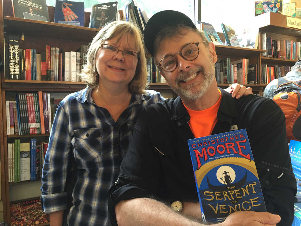 Internationally best-selling author Christopher Moore and Hearthside Books owner Brenda Weaver pose with Moore's 2014 book "The Serpent of Venice." Moore is in Juneau to visit friend, reknowned whale photographer and Juneau resident Flip Nicklin, whom Moore got to know while researching his 2003 book "Fluke, or, I Know Why the Winged Whale Sings." Mary Catharine Martin | Capital City Weekly