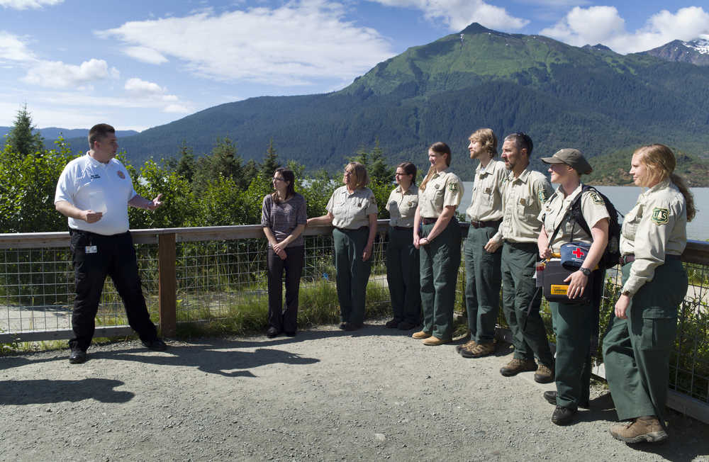 Capital City Fire/Rescue Fire Chief Rich Etheridge, left, conducts a ceremony Tuesday to honor Mendenhall Glacier Visitor Center staff and 911 dispatcher Sayde Ridling, second from left, whose efforts saved the life of a heart attack victim on June 14 at the Visitor Center. The honorees were presented life-saving certificates and Chain of Survival medals. The Forest Service staff are from right: Melissa Baechle, Janet Anderson, Pete Schneider, Clint Augustson, Stephanie Bogle, Lauren Parker and Anne McLean.