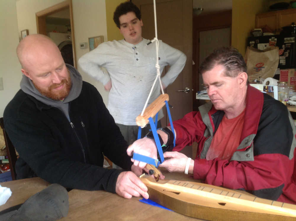 Tim Huber, right, plays the dulcimer. After his stroke, he couldn't move the right side of his body the same way. It was important to him to regain the ability to walk in the months after he woke up, so he focused more on his right leg than arm.