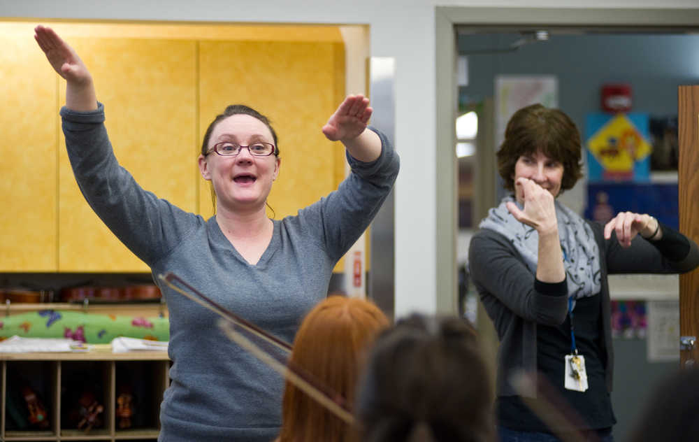 Music instructors Meghan Johnson, left, and Lorrie Heagy direct first graders in the Juneau Alaska Music Matters (JAMM) program at Glacier Valley Elementary School in December 2014. Johnson is the principal cellist for the Juneau Symphony.