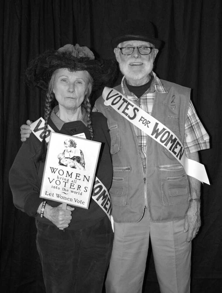 From left to right: LWV of Juneau President carolyn Brown and member George Brown pose in a suffrage-themed photo booth during the organization's annual wine tasting and silent auction fundraiser on Oct. 14, 2016.