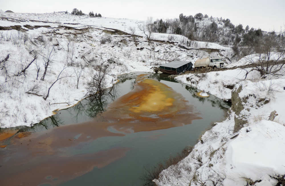 This Dec. 10, 2016 photo, shows an oil spill from the Belle Fourche Pipeline that was discovered Dec. 5 in Ash Coulee Creek, a tributary of the Little Missouri River, near Belfield, North Dakota. President Barack Obama's administration has scaled back new safety measures for the sprawling network of fuel pipelines that crisscross the United States after complaints from industry over the potential cost.