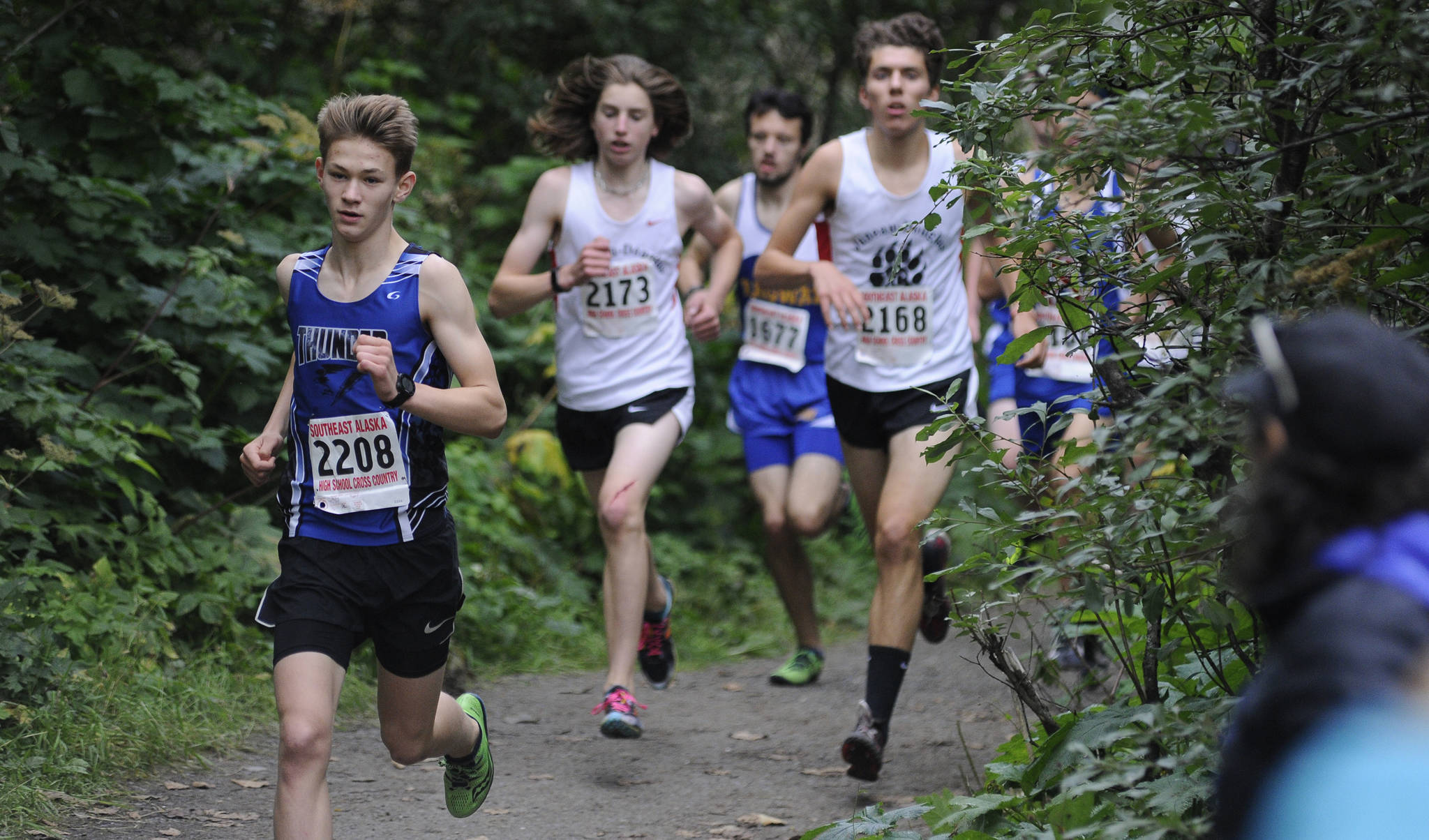 Thunder Mountain’s Tucker Kelly leads Juneau-Douglas’ Ronan Davis, right, and Finn Morley, middle, during the Douglas Island Mini-Meet on the Treadwell Mine Historic Trails on Saturday. (Nolin Ainsworth | Juneau Empire)