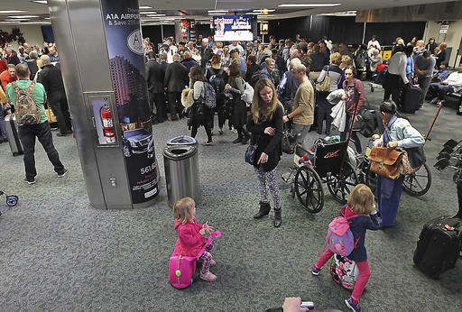 A crowd gathers around the baggage carousel in terminal 2 at Fort Lauderdale-Hollywood International Airport in Fort Lauderdale, Florida on Sunday, Jan. 8, 2017.