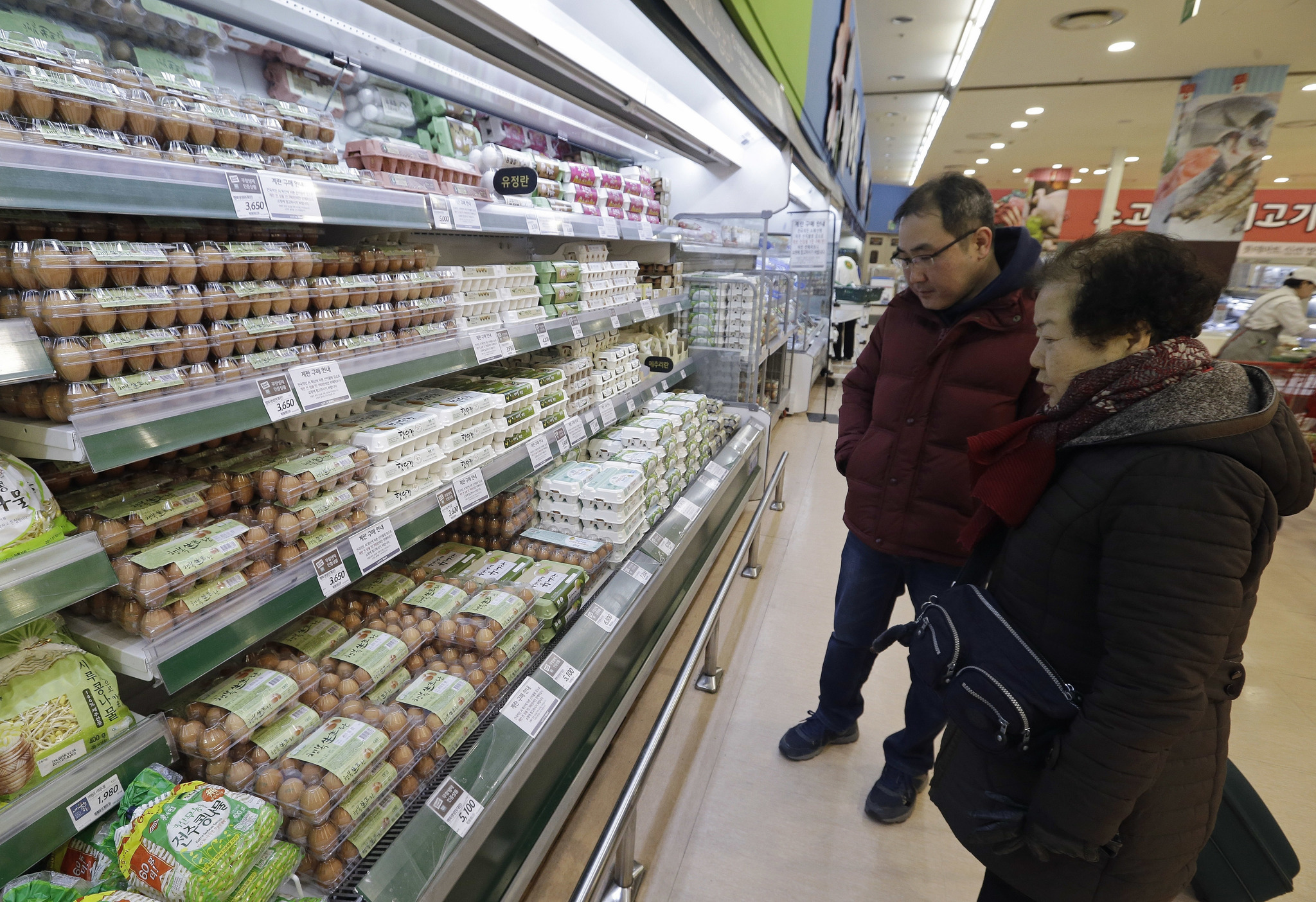 In this Dec. 28 file photo, customers look at eggs at a discount store in Seoul, South Korea. (AP Photo | Ahn Young-joon, File)