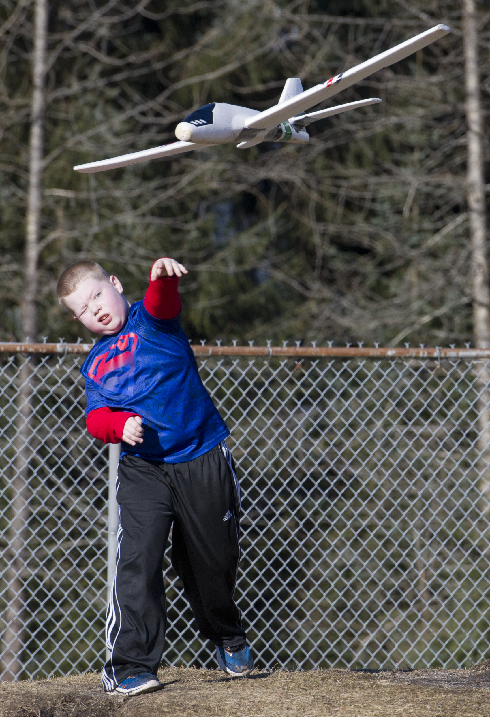 Justinian Sutton, 8, launches a friends glider while out in the sun at Melvin Park on Monday, Feb. 20, 2017. (Michael Penn | Juneau Empire)