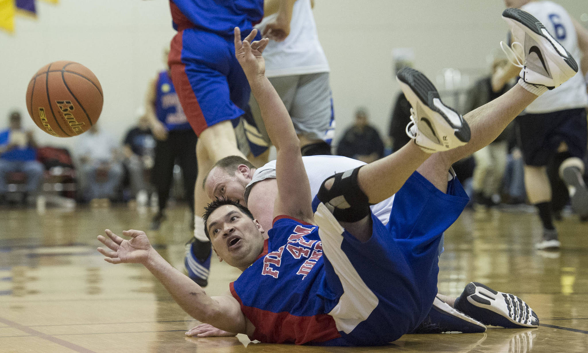 Filcom’s Franz Kugelmann passes after stealing the ball from AK Caches/James Gang’s Sean Smith during their C bracket game at the Lions Club’s Gold Medal Basketball Tournament at Juneau-Douglas High School on Sunday, March 19, 2017. Filcom won 59-51. (Michael Penn | Juneau Empire)