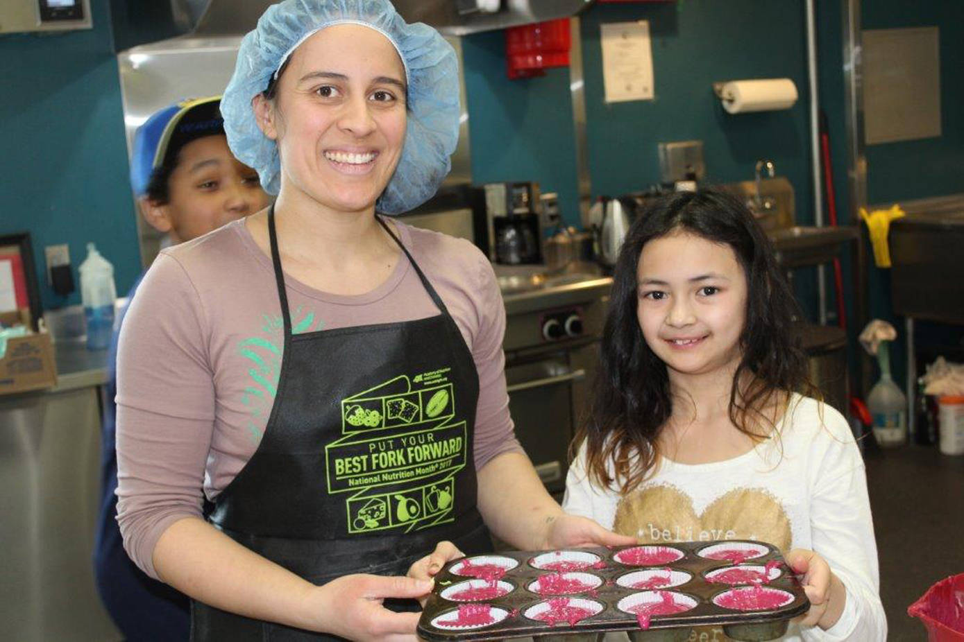 Bartlett Regional Hospital nutrition and dietetic technician Theresa Reynolds bakes up beet cupcakes with avocado icing with help from Abigail. (Courtesy photo)