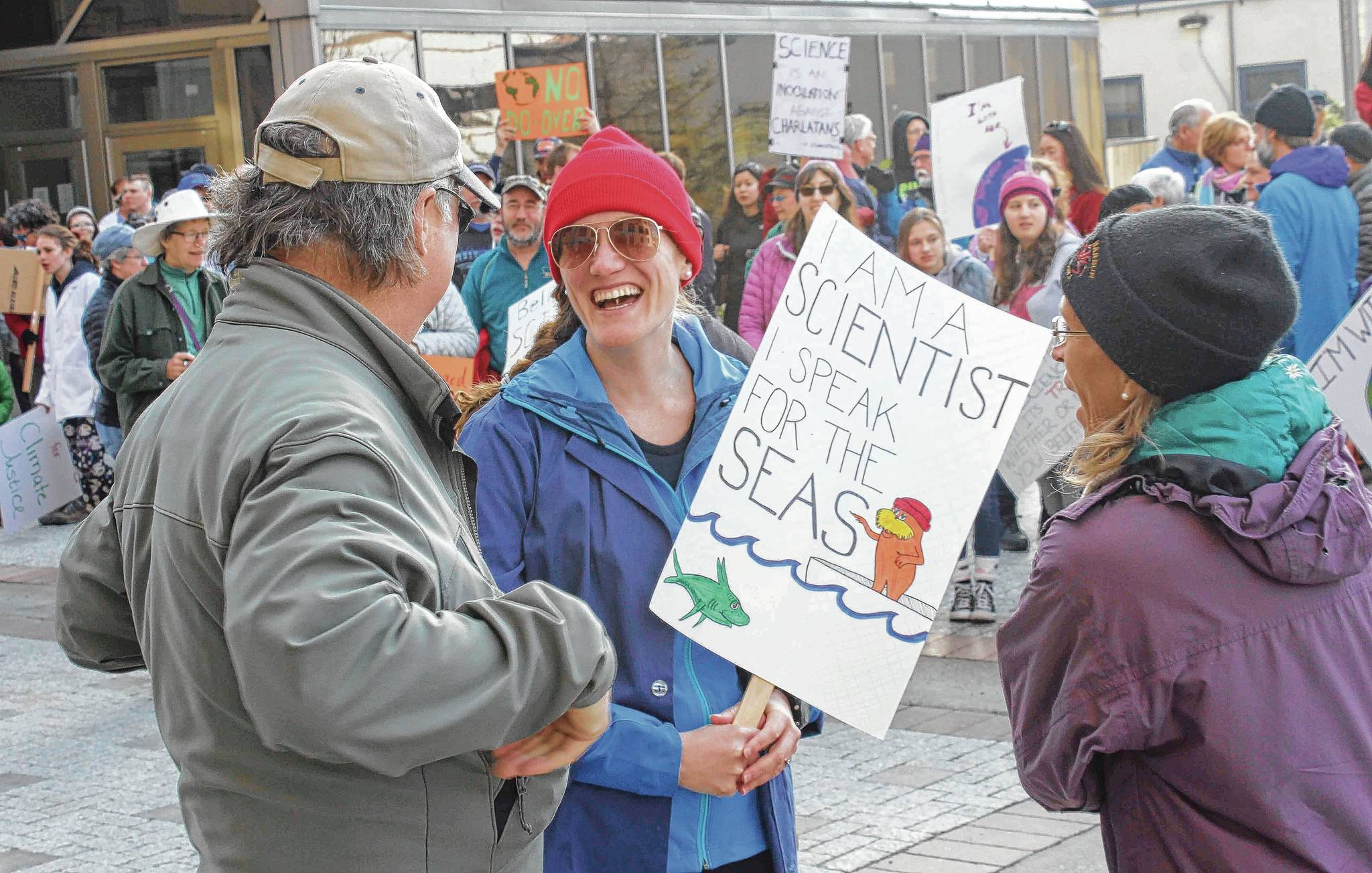 Molly Zaleski talks with other demonstrators at Saturday’s March for Science. The march was one of more than 600 worldwide. (Alex McCarthy | Juneau Empire)