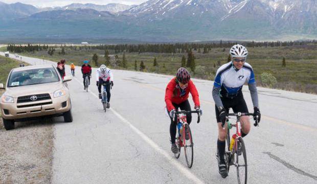 In this file photo from 2014, Juneau’s Scott May, right, rides in the Kluane Chilkat International Bike Relay. (Photo courtesy Jim Grammel)