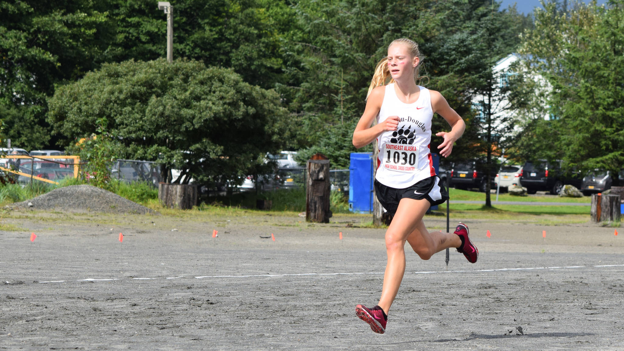 Juneau-Douglas High School sophomore Sadie Tuckwood sprints the final 100 meters of the Capital City Invitational, Saturday, Aug. 26, 2017. Tuckwood won the Palmer Invitational on Saturday. (Nolin Ainsworth | Juneau Empire File)