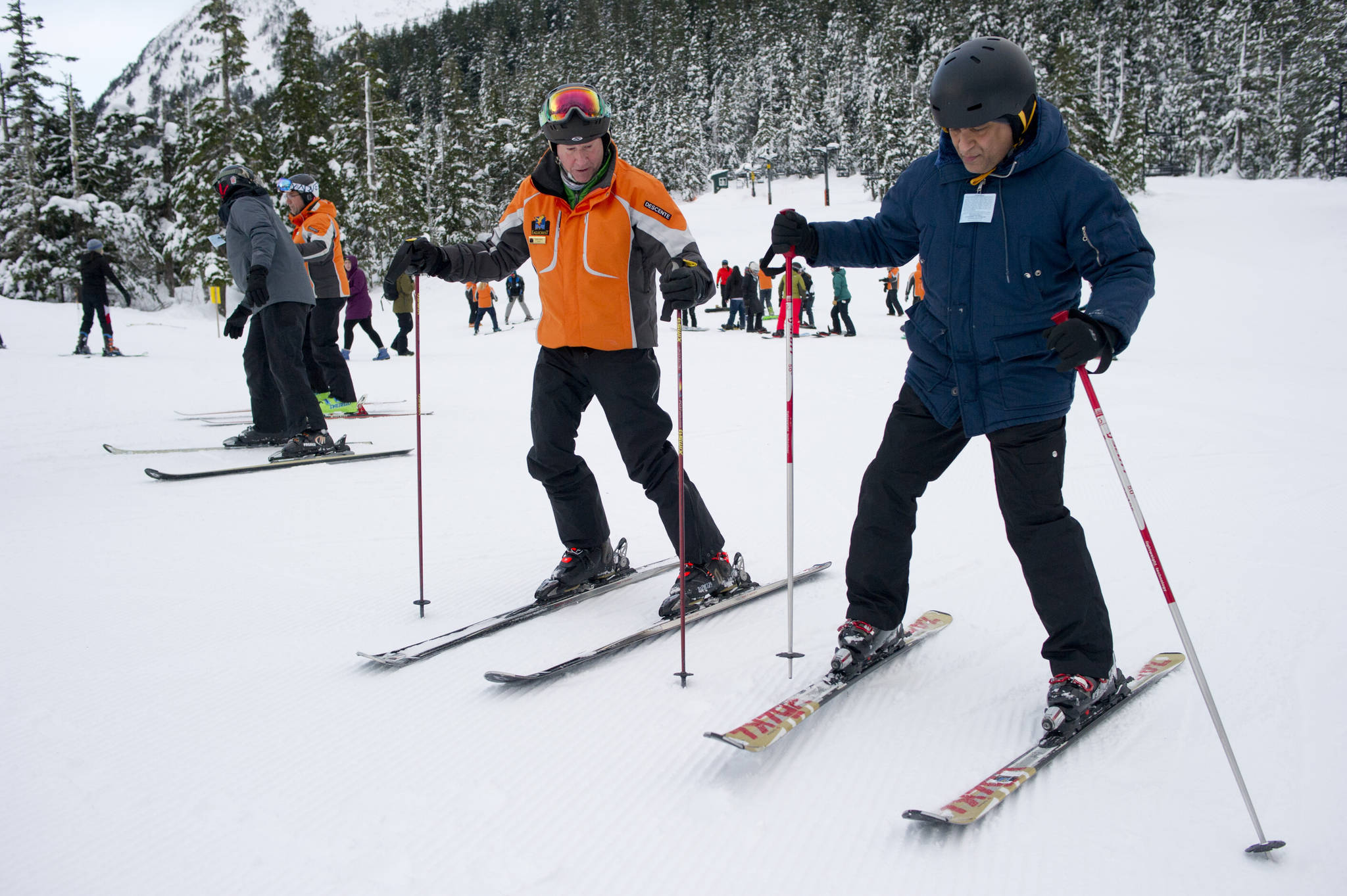 In this Jan. 6 photo, instructor Scott Fischer helps Pradeep Chhabria, right, learn to ski during the World’s Largest Lesson at Eaglecrest Ski Area. (Michael Penn | Juneau Empire File)