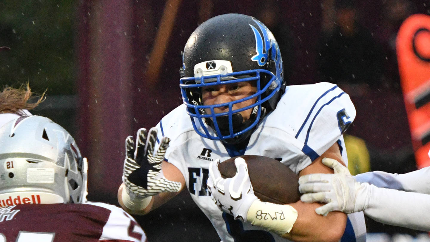 Thunder Mountain senior running back Roy Tupou dashes through defenders Friday, Sept. 8, 2017, during the Falcons’ 42-9 win against Ketchikan High School at Esther Shea Field. Tupou scored a 51-yard touchdown in the game. (Taylor Balkom | Ketchikan Daily News)