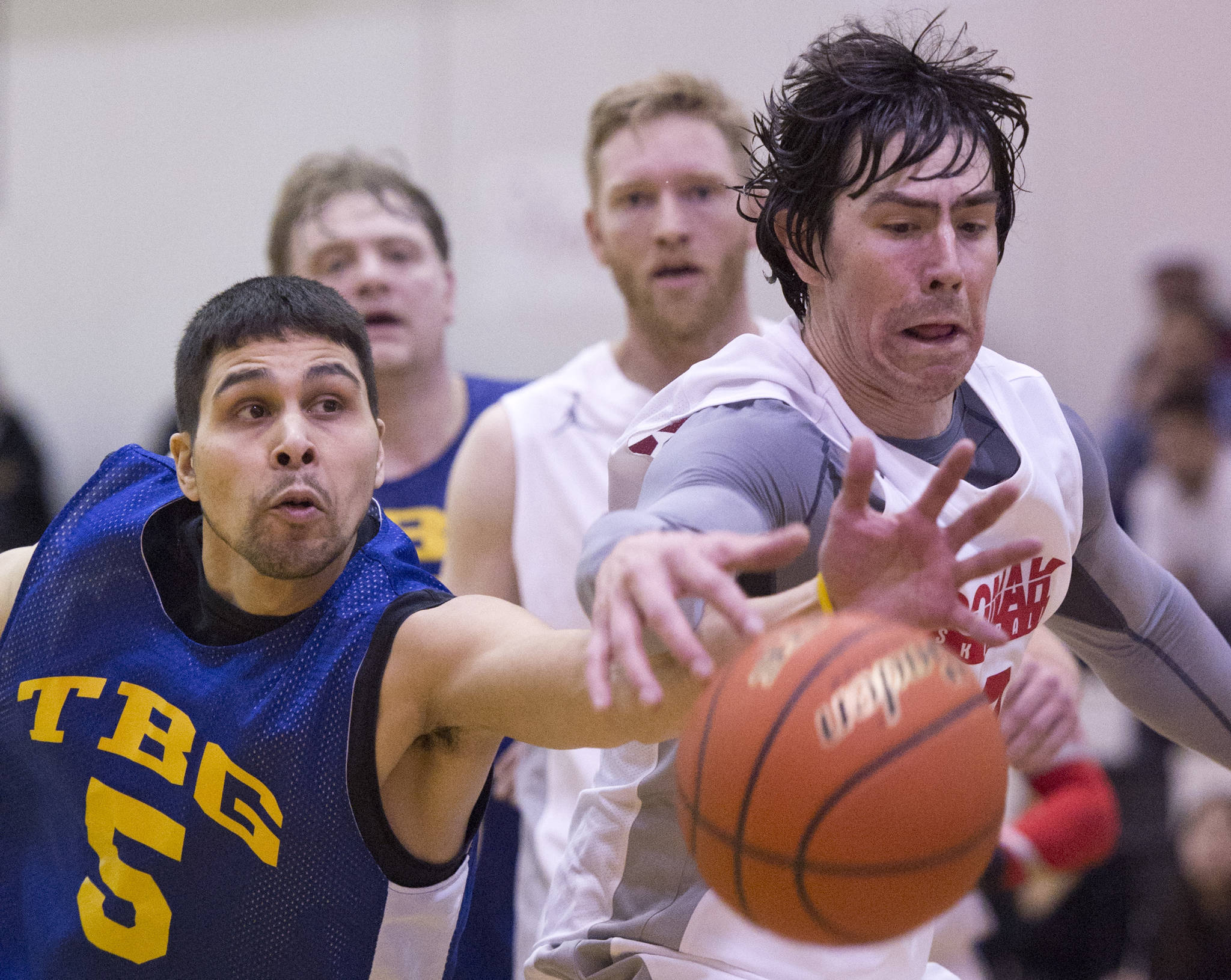 In this March 23, 2017 photo, Juneau James Gang’s Billy Ehlers chases a loose ball against Hoonah’s Donald Dybdahl in their C Bracket game in the Lions Club’s Gold Medal Basketball Tournament at Juneau-Douglas High School. (Michael Penn | Juneau Empire File)