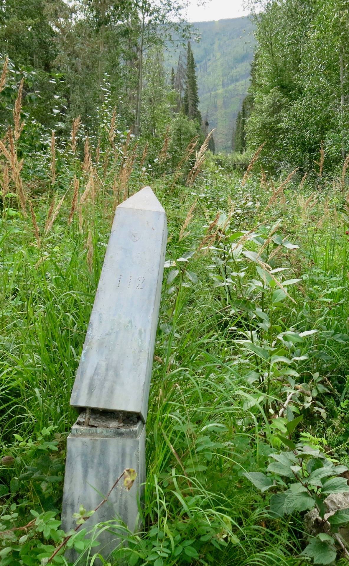 Boundary monument 112, damaged by river ice, at the Yukon River crossing east of Eagle. (Photo by Ned Rozell)