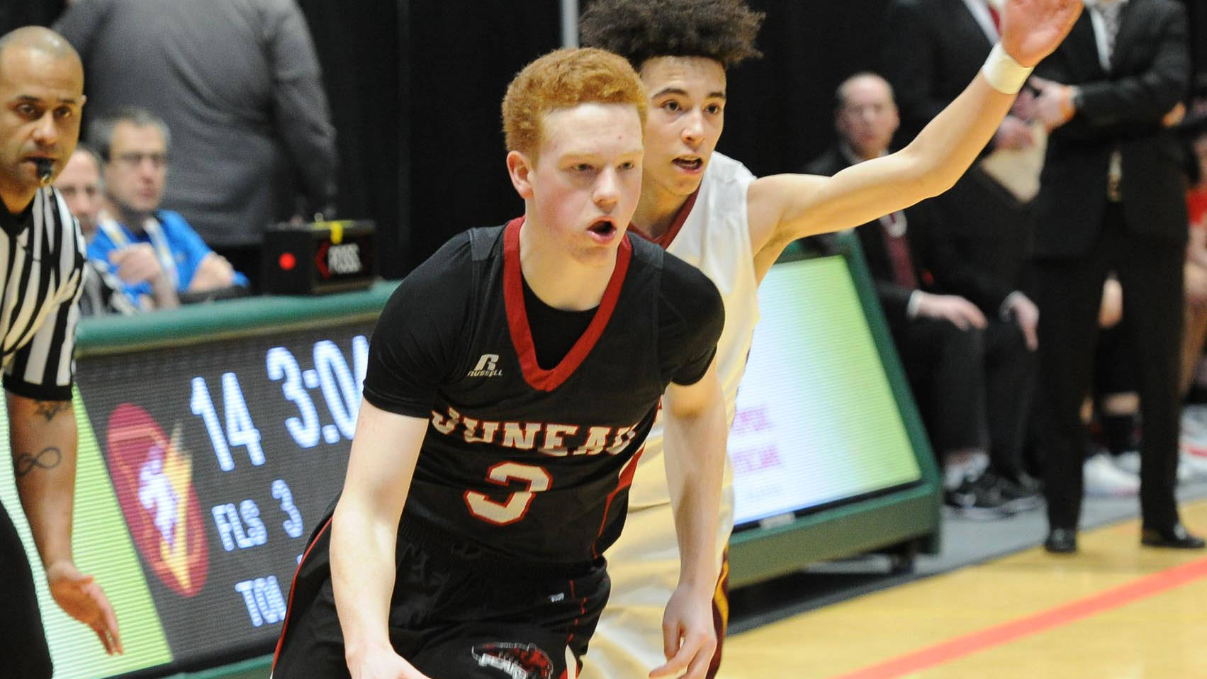 Juneau-Douglas High School senior Luke Mallinger drives past Dimond High School sophomore Isaiah Moses Thursday in the ASAA/First National Bank Alaska state basketball championships. JDHS rebounded from a 48-39 loss to Dimond with a 59-52 win over West Valley on Friday. (Michael Dinneen | For the Juneau Empire)