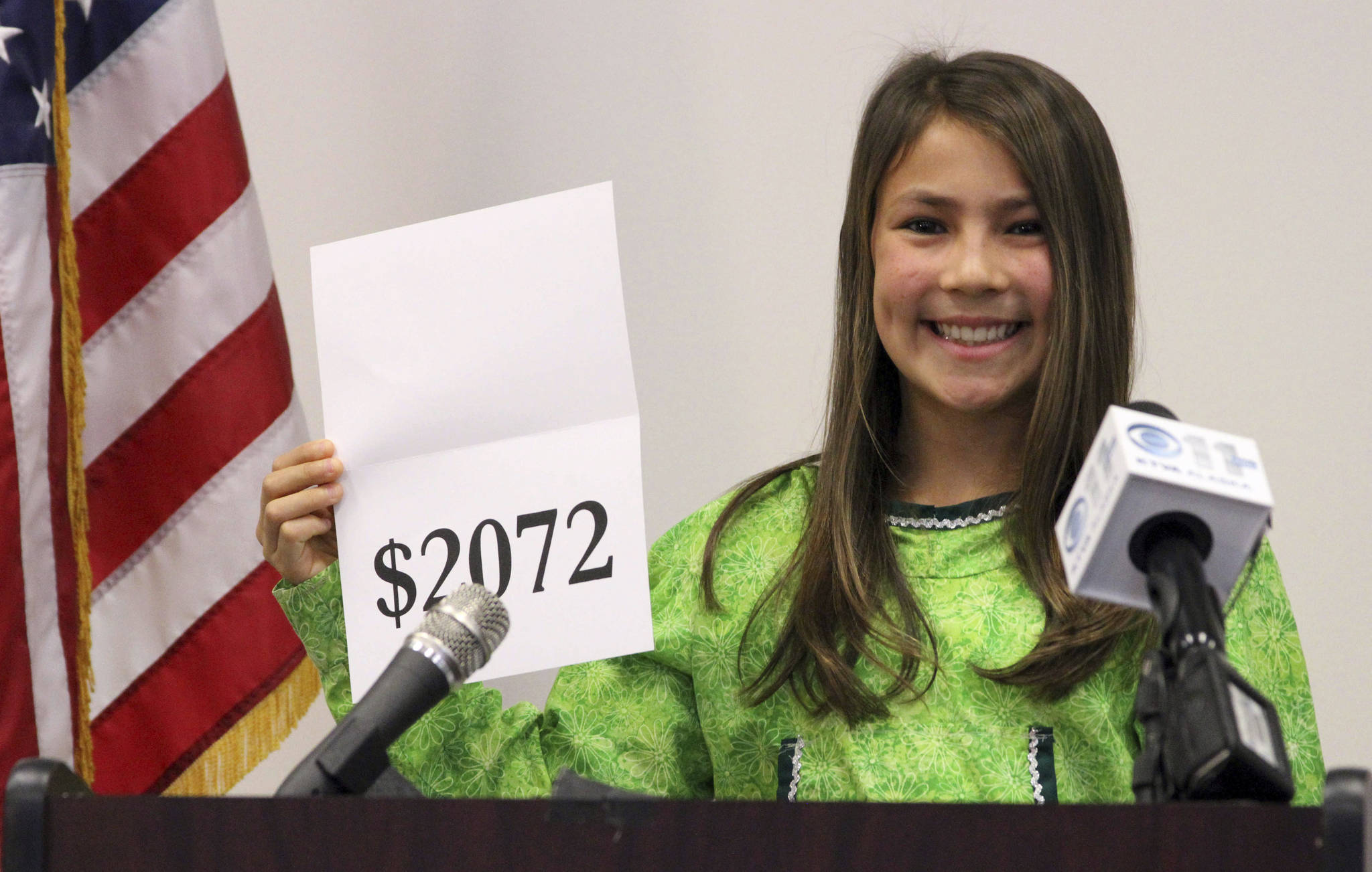 In this Monday, Sept. 21, 2015 photo, student Shania Sommer of Palmer announces that nearly every Alaskan will receive $2,072 from the year’s oil dividend check during a news conference in Anchorage. Alaska lawmakers, faced with limited options for filling the state’s budget deficit, may have to dip into earnings from Alaska’s famed oil-wealth fund, with major proposals for doing so calling for changes to how the yearly checks that residents receive from fund earnings are calculated. (AP Photo/Mark Thiessen, File)