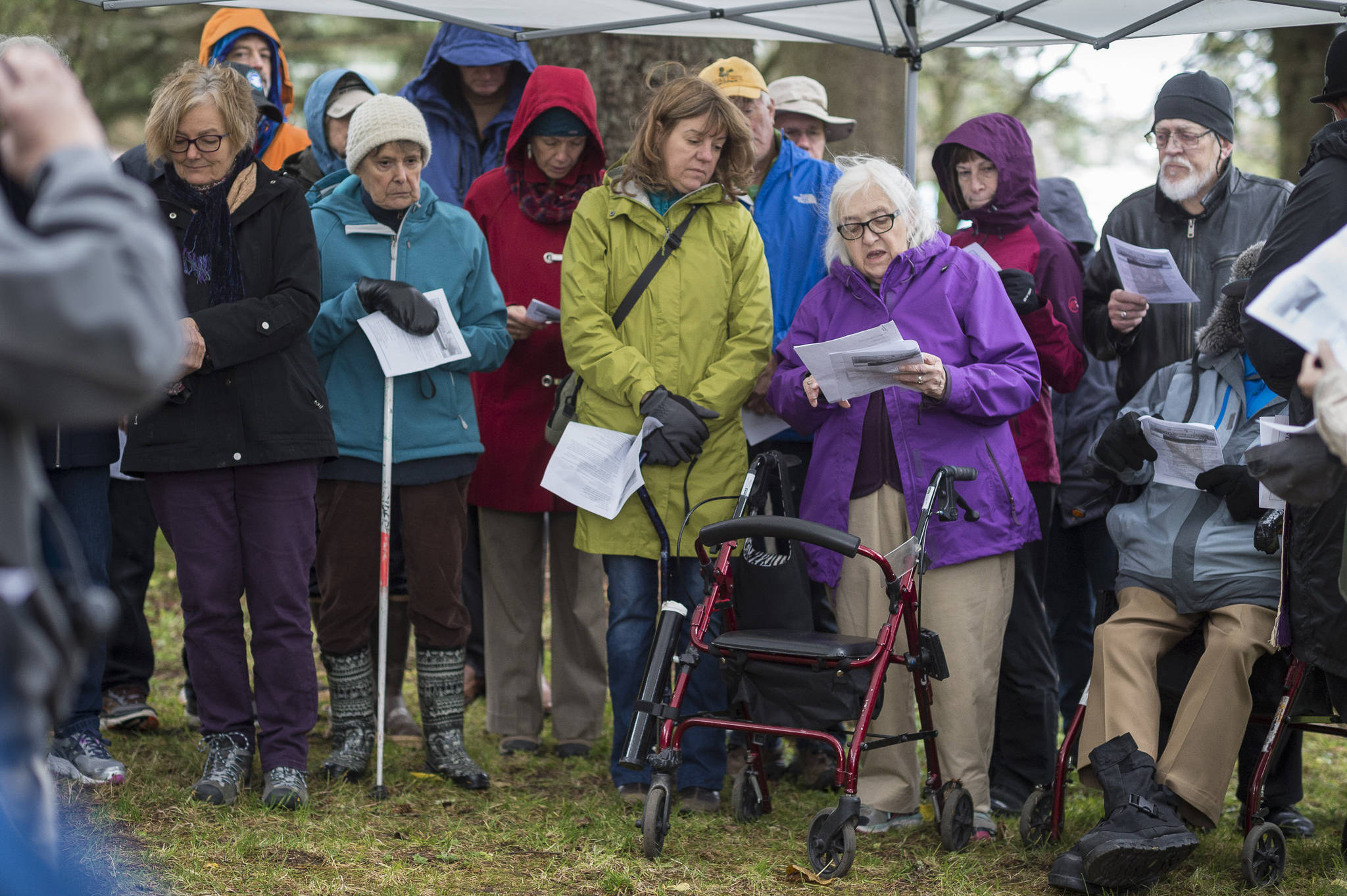 Mary Lou Spartz reads the names of victims buried at the Evergreen Cemetery during a memorial service on Thursday, Oct. 25, 2018, on the 100th anniversary of the sinking of the Princess Sophia. The service takes place at the gravesite of Walter Harper and his wife, Frances Wells. (Michael Penn | Juneau Empire)