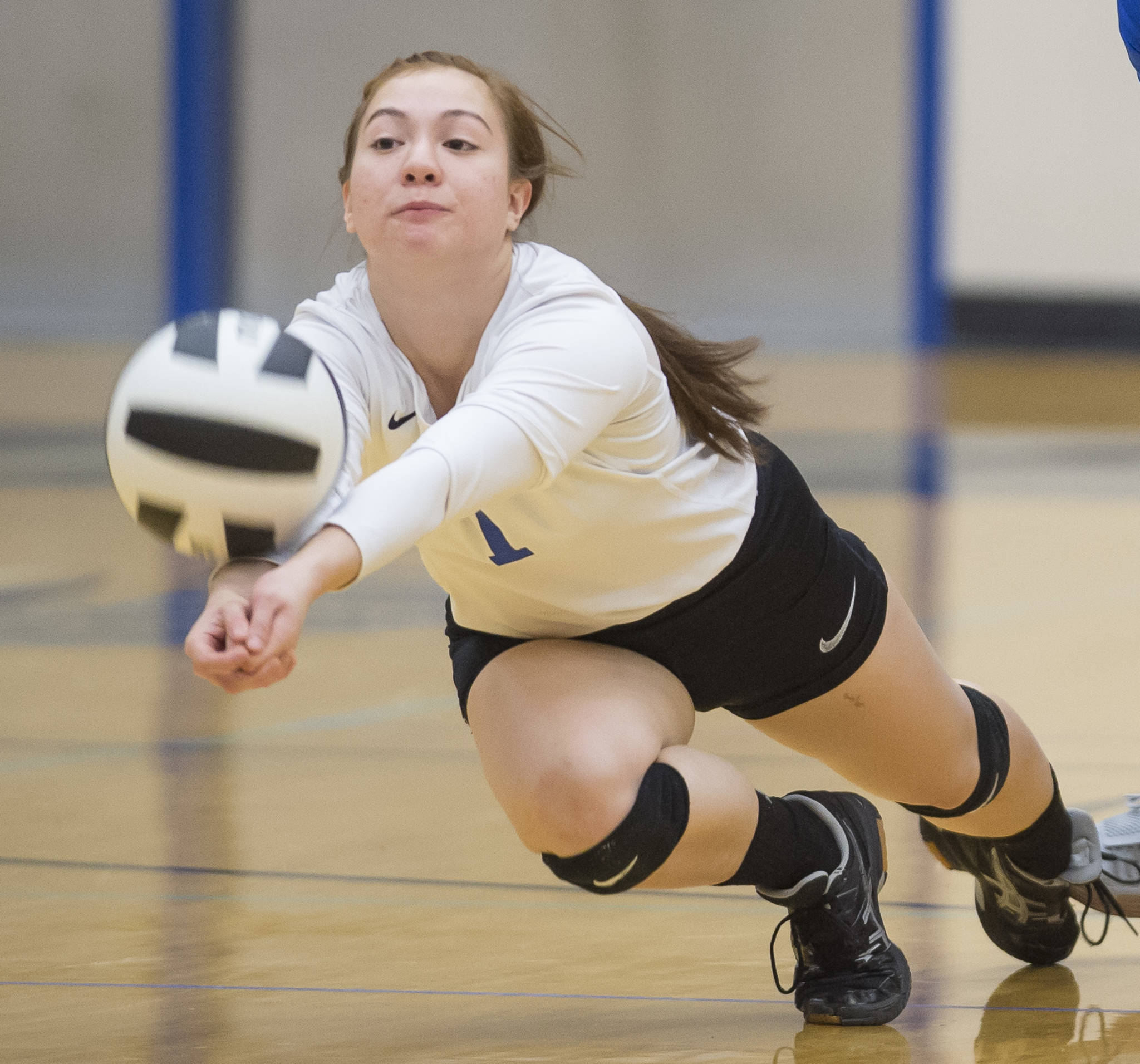 Thunder Mountain’s Leilani Eshnaur dives for the ball against Juneau-Douglas at TMHS on Friday. (Michael Penn | Juneau Empire)