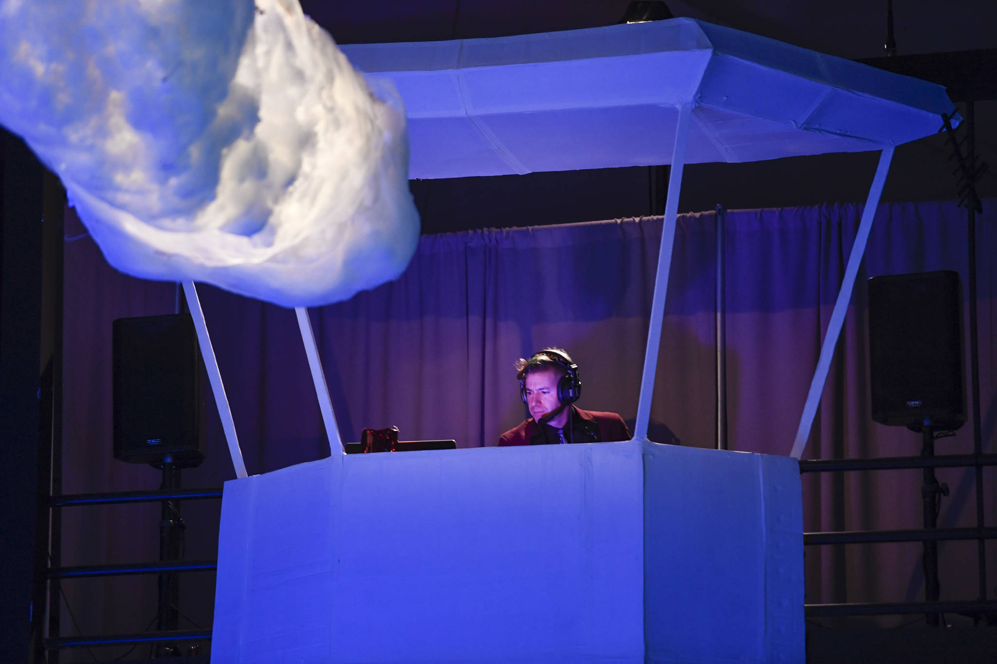 DJ Manu takes control of the air waves from his control tower at the Wearable Art show at Centennial Hall on Saturday, Feb. 16, 2019. (Michael Penn | Capital City Weekly)