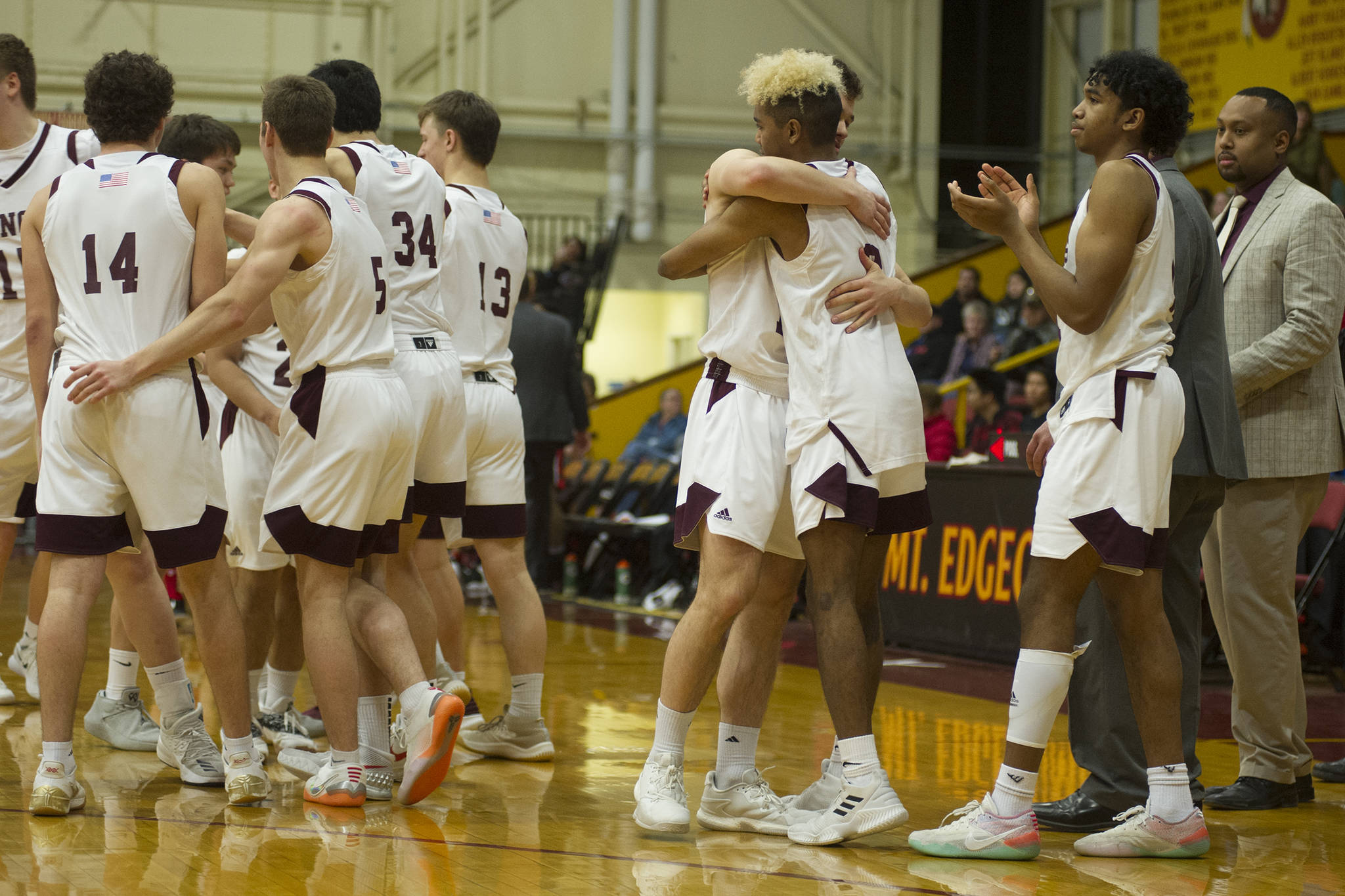 The Ketchikan boys basketball team celebrates its 66-60 victory over Juneau-Douglas in the Region V 4A championship game at the B.J. McGillis Gymnasium at Mt. Edgecumbe High School on Friday, March 8, 2019. (Nolin Ainsworth | Juneau Empire)