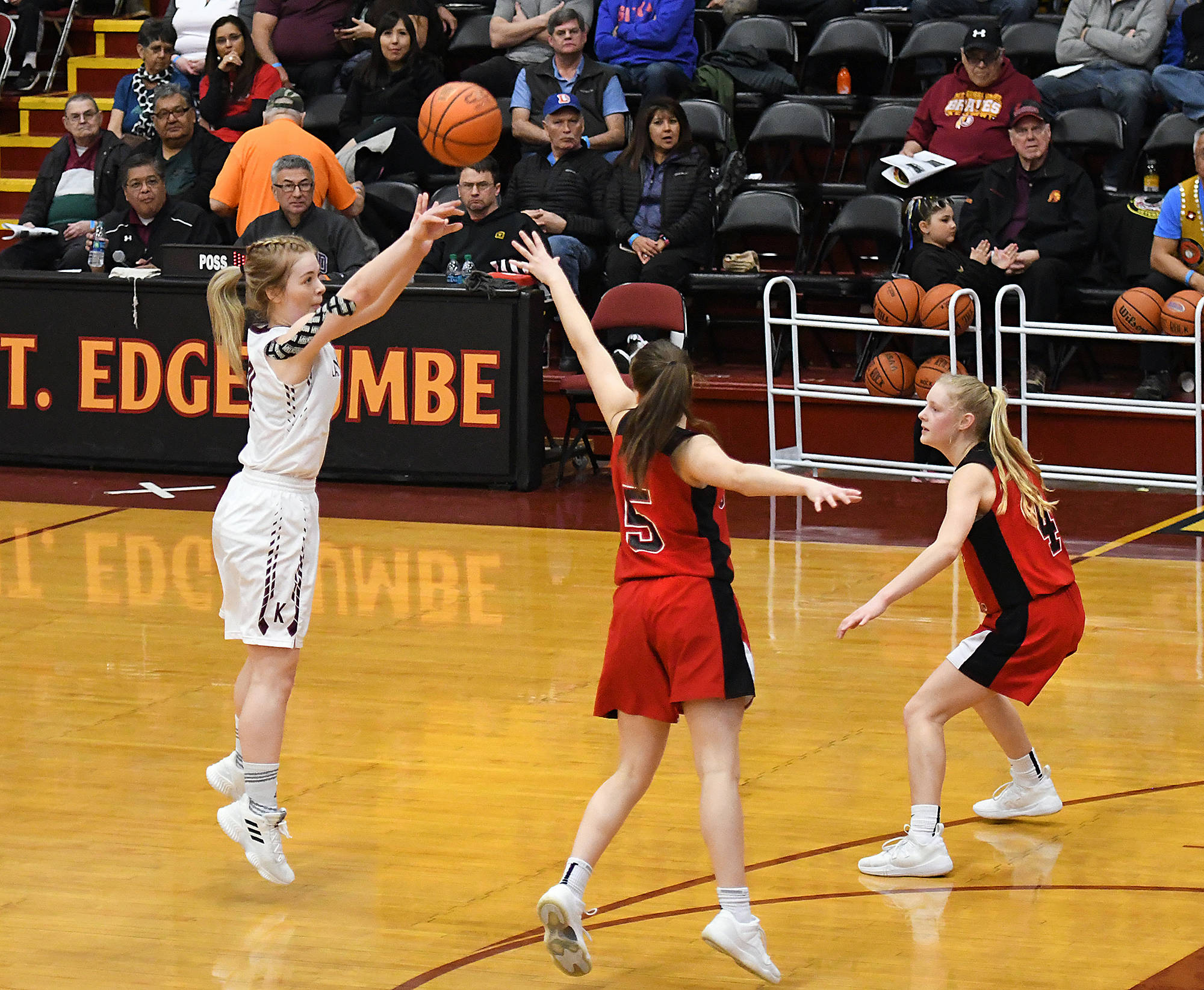 Ketchikan senior Ashley Huffine makes a shot over Juneau-Douglas sophomore Kiana Potter and junior Sadie Tuckwood during a 47-43 Kayhi victory at the Region V 4A championship match in the B.J. McGillis Gymnasium at Mt. Edgecumbe High School in Sitka. (Dustin Safranek | Ketchikan Daily News)