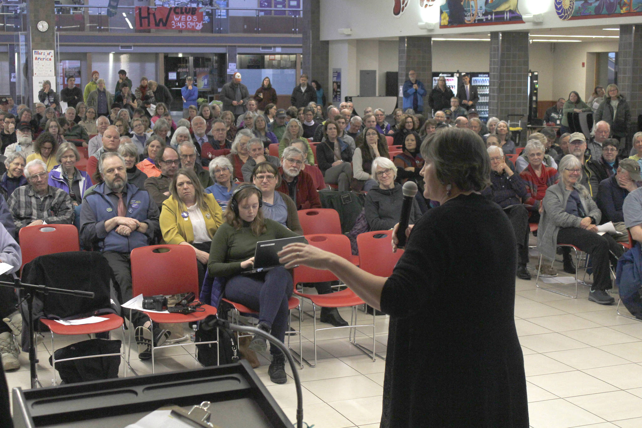 Rep. Sara Hannan, D-Juneau, speaks while a crowd listens at a town hall meeting on Tuesday at Juneau-Douglas High School. (Alex McCarthy | Juneau Empire)