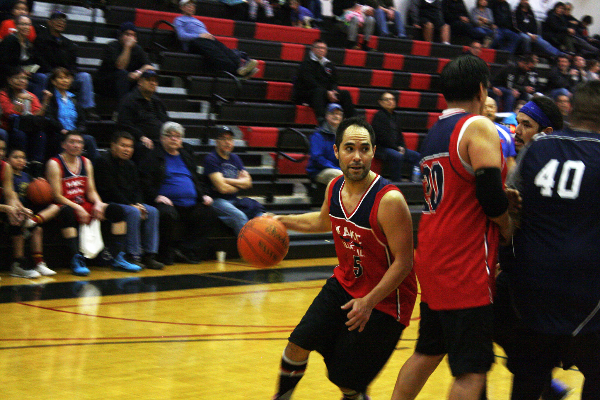 Rudy Bean dribbles the ball during Kake’s big win over Angoon that kicked off Monday’s action for the Gold Medal Basketball Tournament. (Ben Hohenstatt | Juneau Empire)