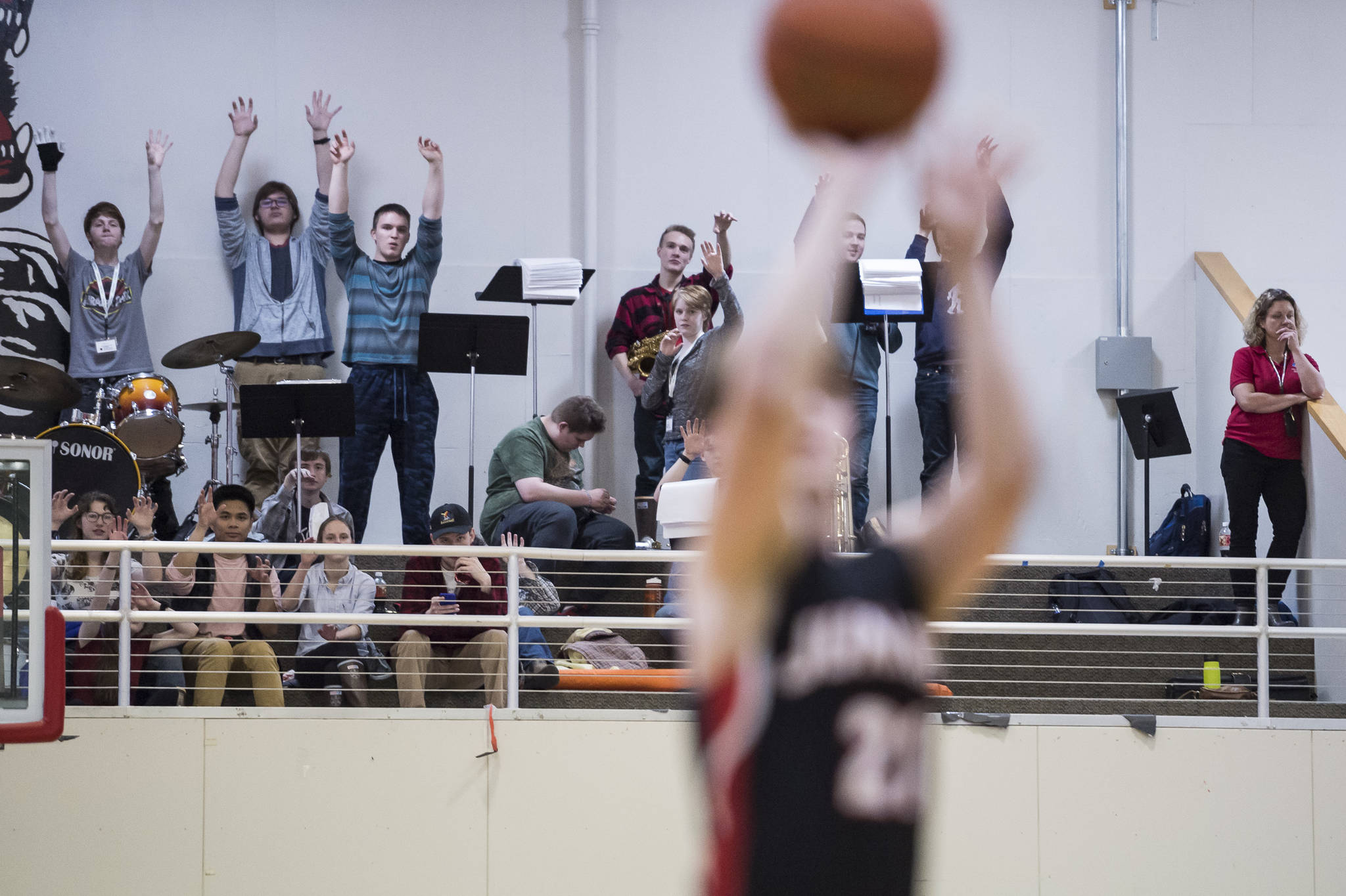 Juneau-Douglas’ Pep Band members show their claws as a JDHS player shoots a free throw against Maine-Endwell at the Princess Cruises Capital City Classic at Juneau-Douglas High School on Saturday, Dec. 29, 2018. Juneau-Douglas won 66-61. (Michael Penn | Juneau Empire File)