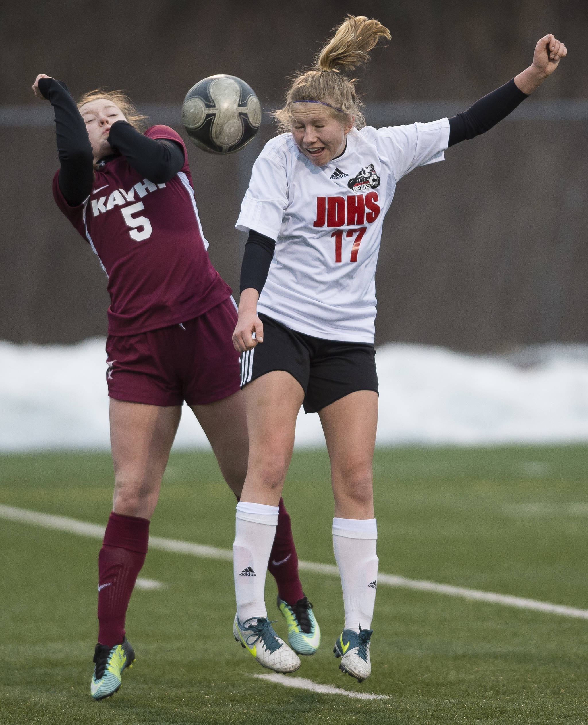 Juneau-Douglas’ Taylor Bentley, right, heads the ball against Ketchikan’s Jessilynn Sivertsen at Thunder Mountain High School on Friday, April 6, 2018. JDHS won 8-0. (Michael Penn | Juneau Empire)