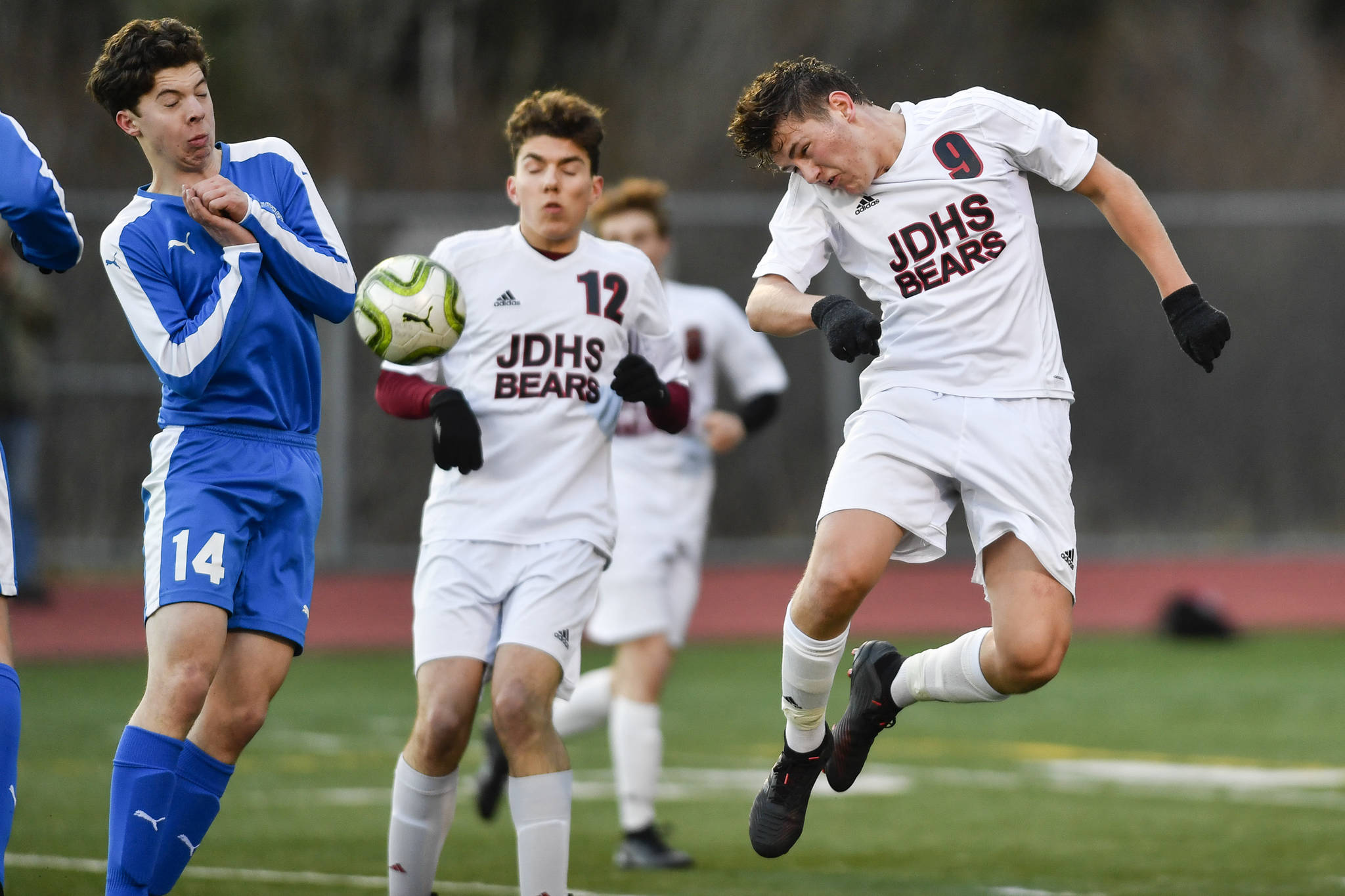 Juneau-Douglas’ Richard Lehner, right, heads a shot against Thunder Mountain’s Jake Babcock during their game at TMHS on Tuesday, April 23, 2019. JDHS won 2-0. (Michael Penn | Juneau Empire)