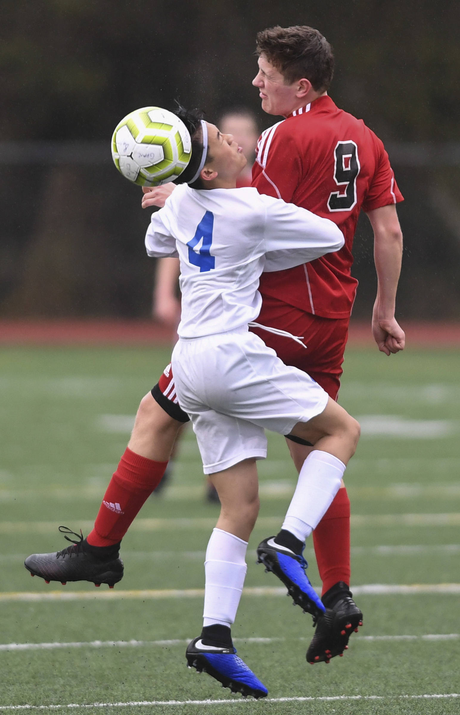 Juneau-Douglas’ Richard Lehner, right, and Thunder Mountain’s Phillip Lam battle for the ball at Adair-Kennedy Memorial Field on Tuesday, May 7, 2019. The game ended tied at 1-1. (Michael Penn | Juneau Empire)